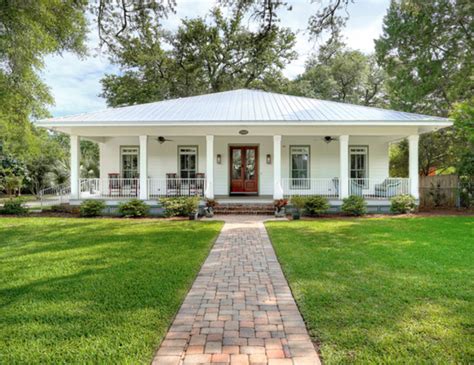 brick house white metal balcony|white house with metal roof.